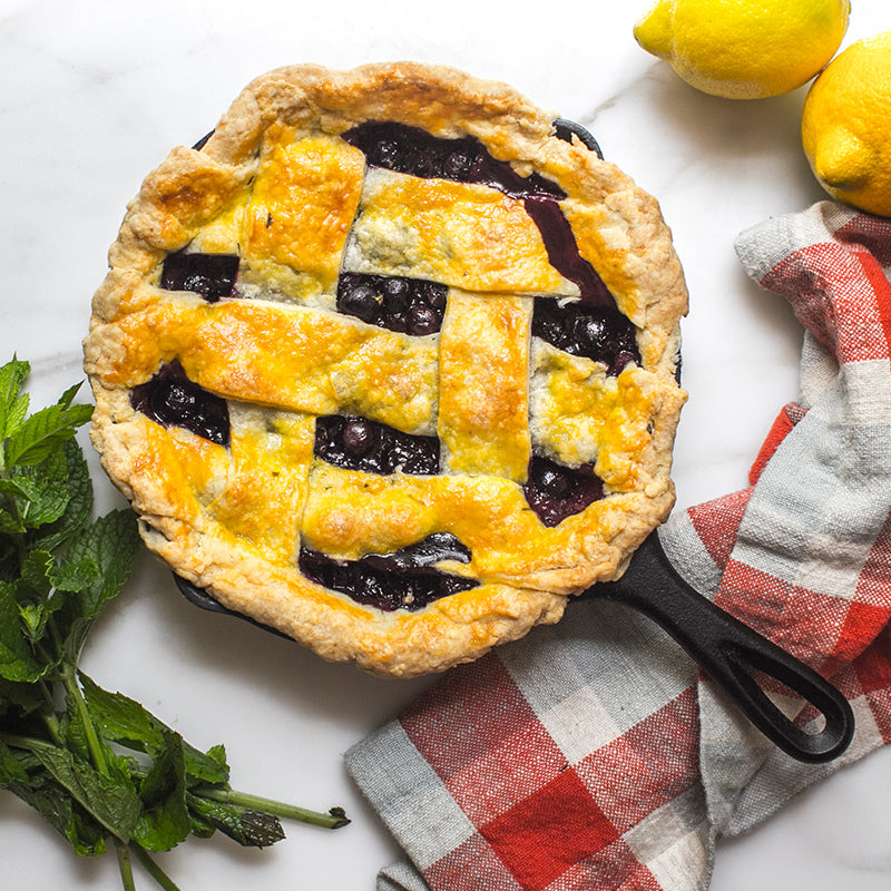 Blueberry pie, freshly baked in cast iron skillet.