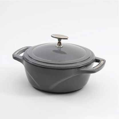 Grey enameled cast iron Dutch oven with a lid on a white background