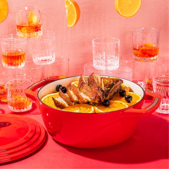 Freshly prepared old fashioned infused pork belly in front of glassed of Old Fashion's and oranges.