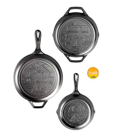 A set of three seasoned cast iron cookware items, including an 8 inch tent skillet, a 10.25 inch dual handle camper pan, a 3.2 Quart Cast Iron Cabin Combo Cooker, and a Wanderlust Logo Sticker.